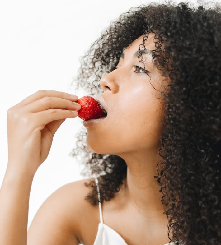 Eating strawberry for teeth whitening 